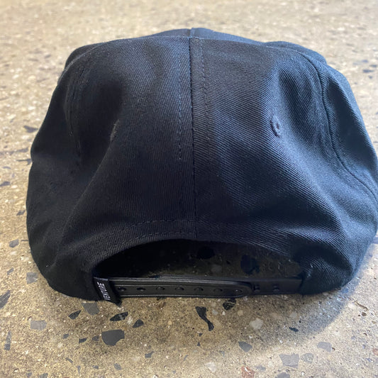 Rear view of black snapback hat, small VENTURE flag label
