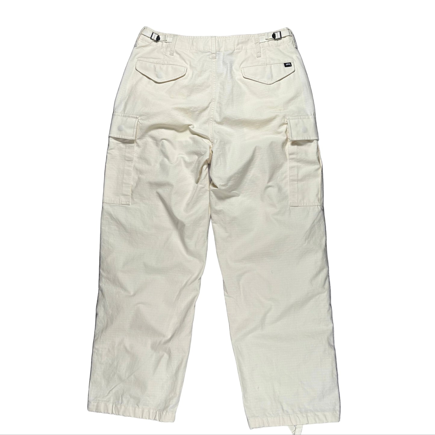 Beige cargo pants on a white surface