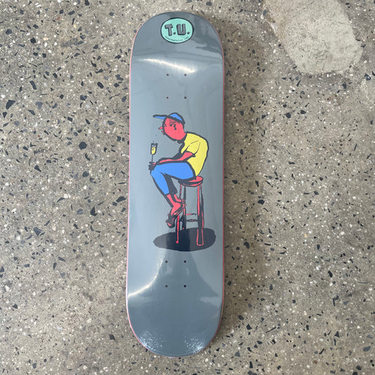 hand drawn multi color graphic of man sitting on chair on grey skate deck 