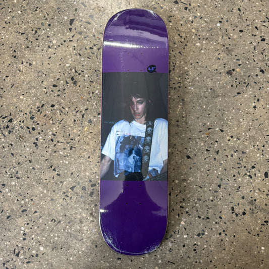 girl playing guitar on purple skate deck