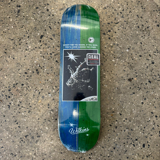 astronaut on green and blue wood grain skate deck (wood grain color may vary)