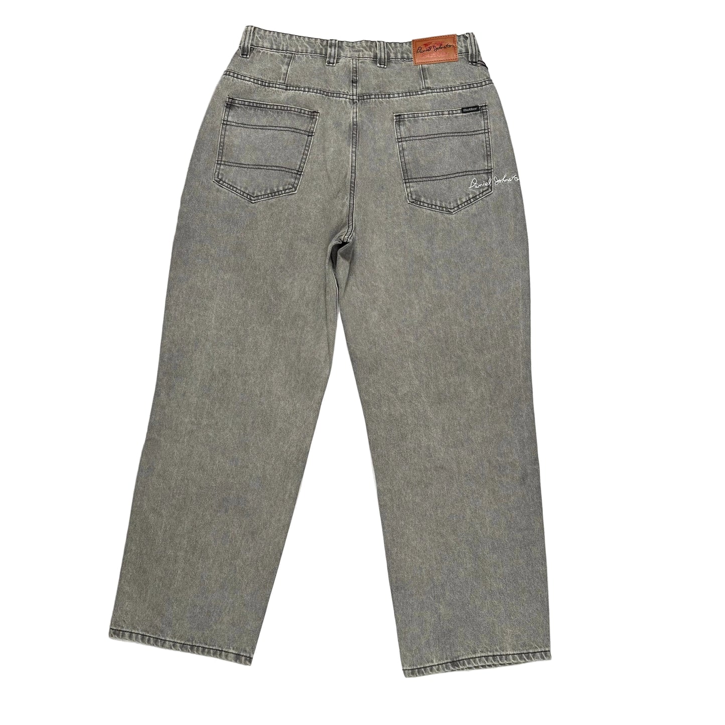 Gray jeans laid flat on a white surface