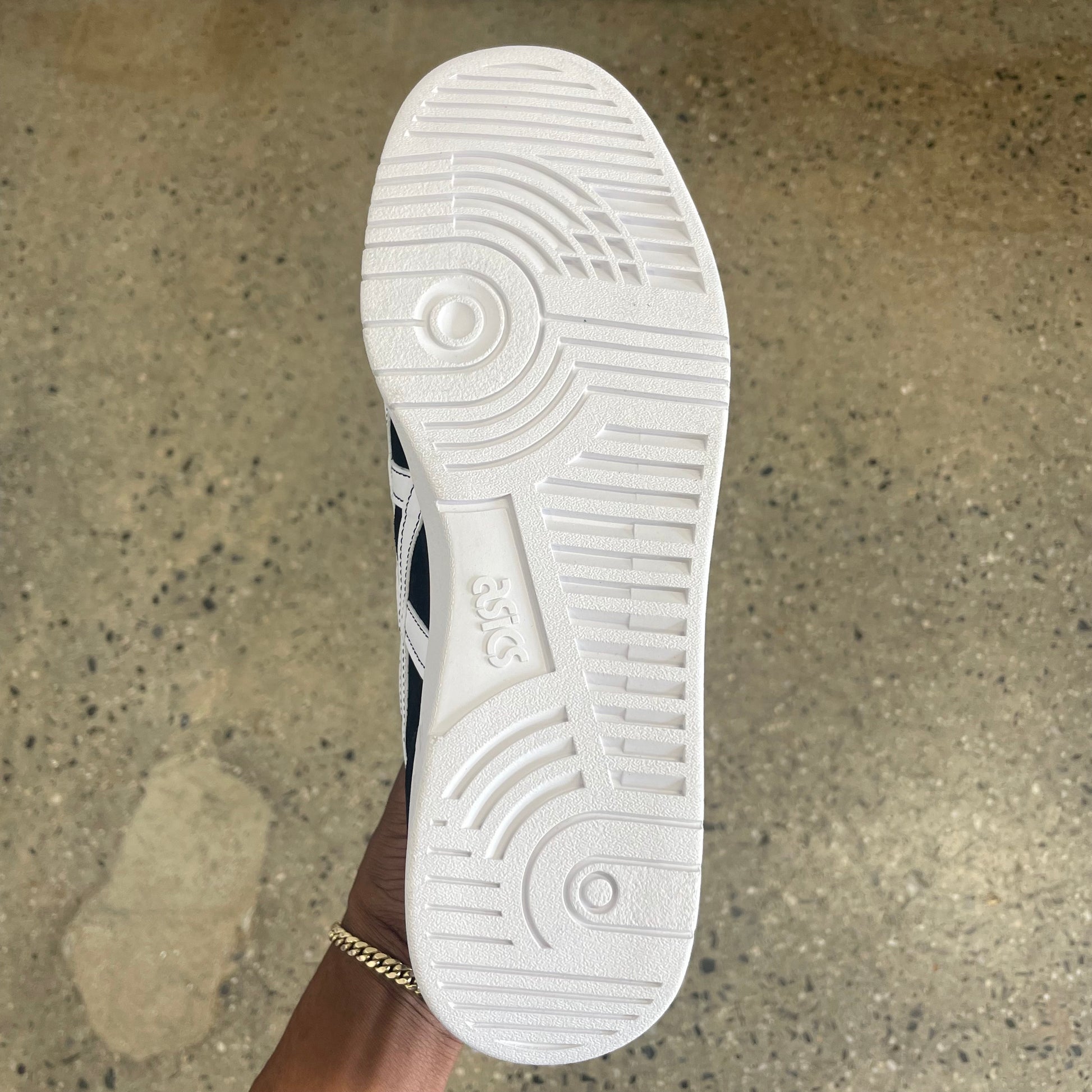 View of white outsole on blackwhite suede skate sneaker