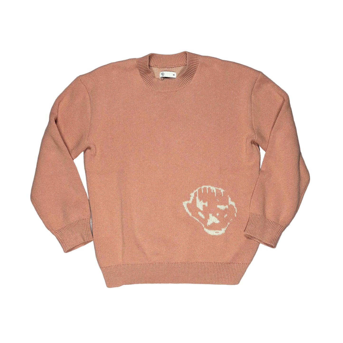 pink sweater with a white logo on a white surface