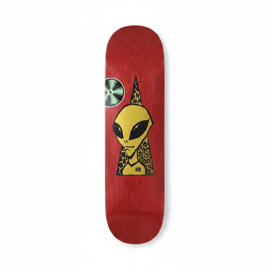 Red skateboard deck with alien and green symbol design on a white surface