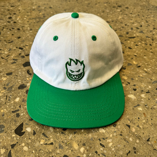 white hat with green brim and green spitffire logo embroidered int he center