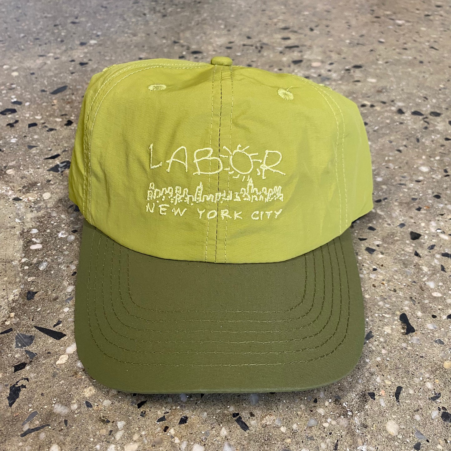 White Hand drawn style LABOR NEW YORK CITY logo on green nylon six panel cap