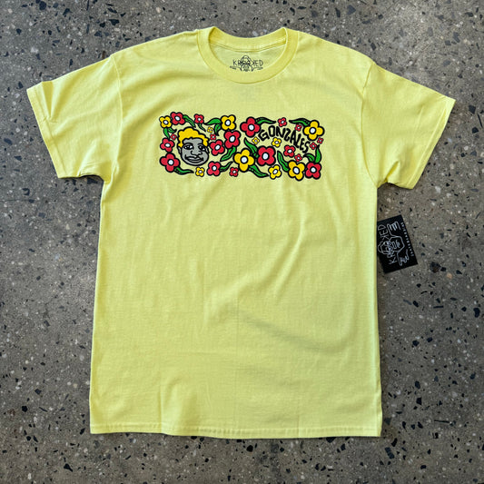 yellow t shirt with multi colored floral graphic in the center