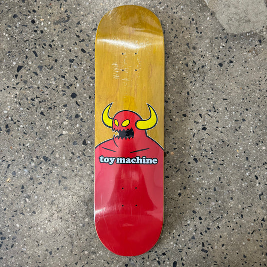 yellow wood stained deck with red toy machine monster on the bottom