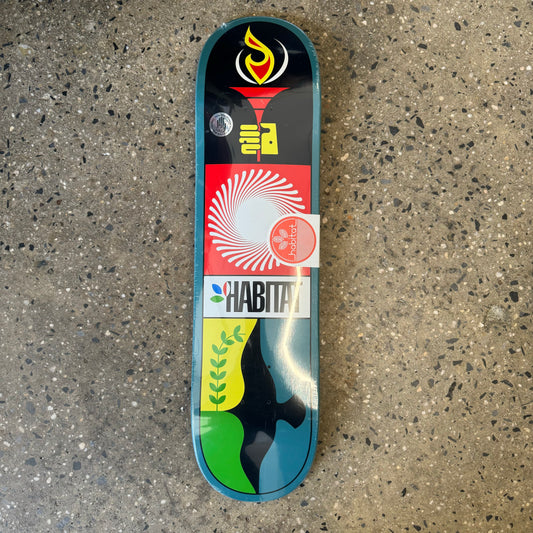 dark teal dipped deck with various black , red and yellow insignia through the center