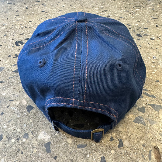 back view of navy cap with orange stitch