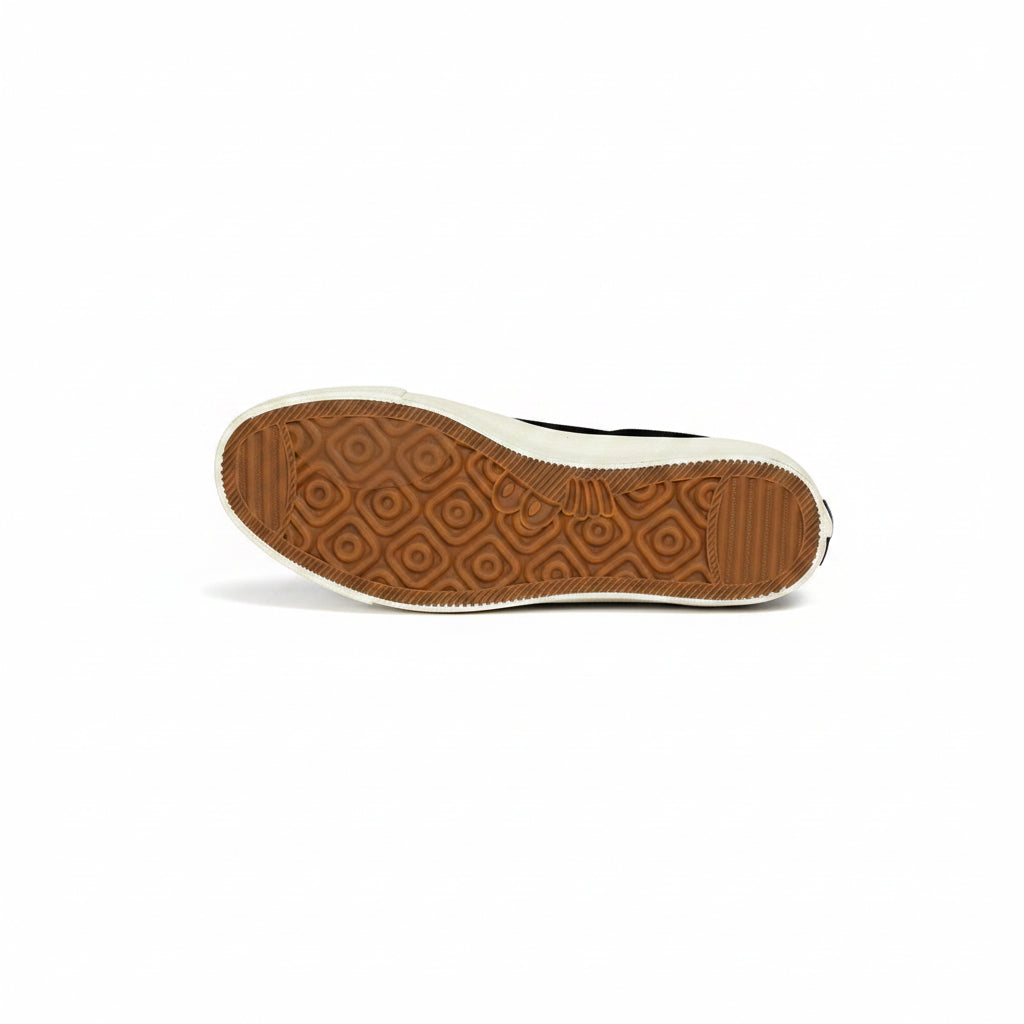 Brown sole of a shoe on a white surface
