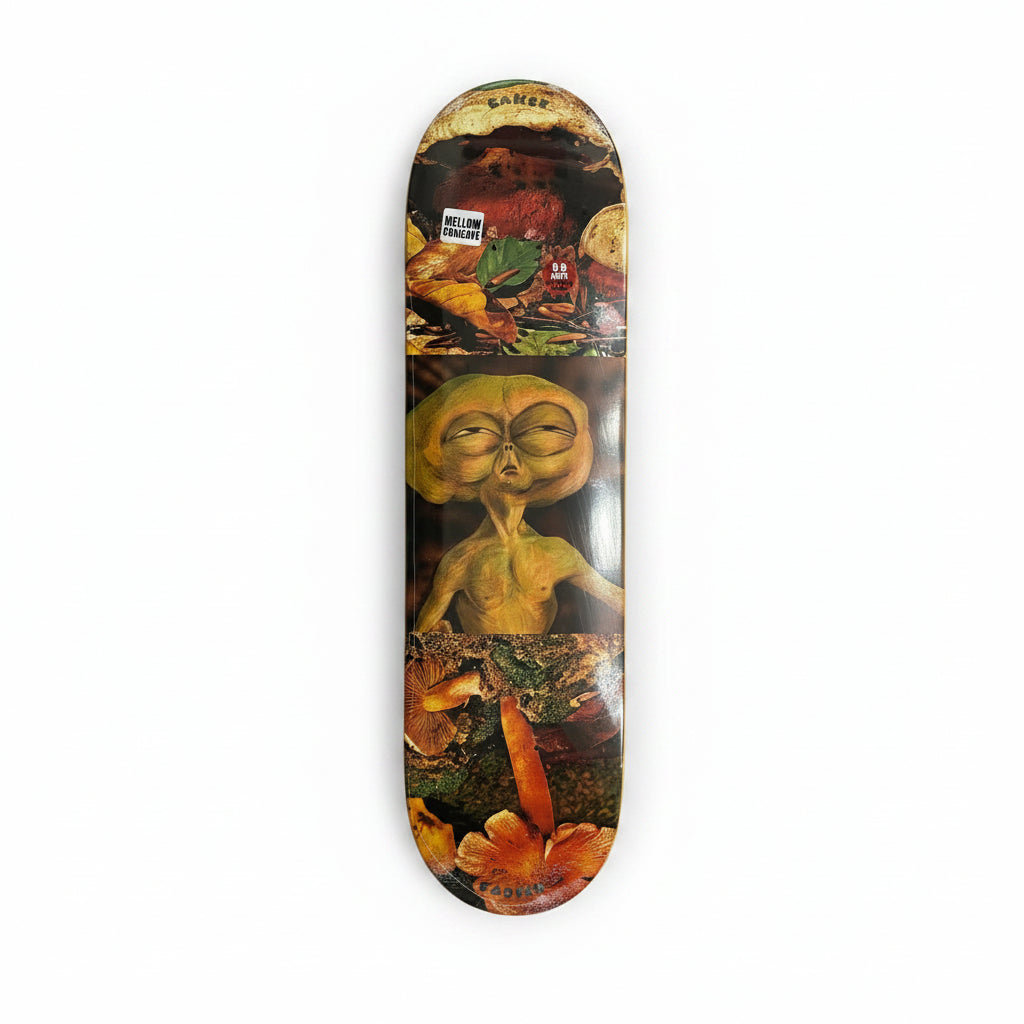 Skateboard deck with alien design on a white surface