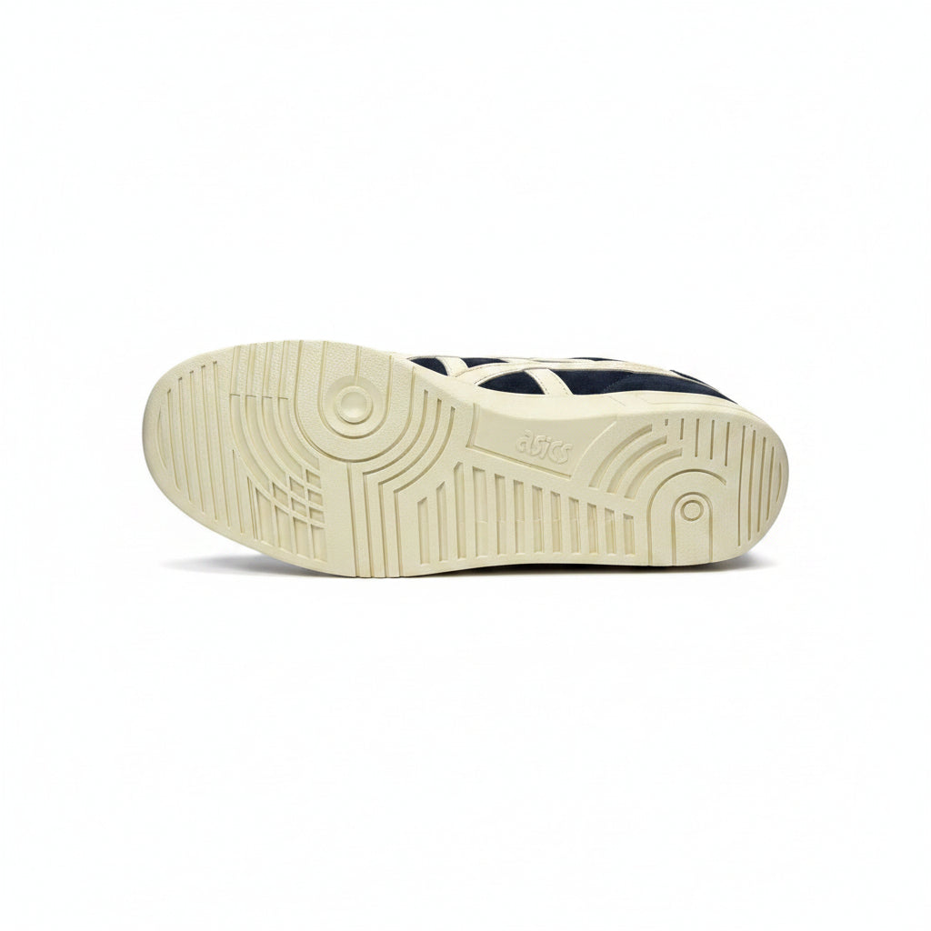 Sole of a navy and white sneaker on a white background