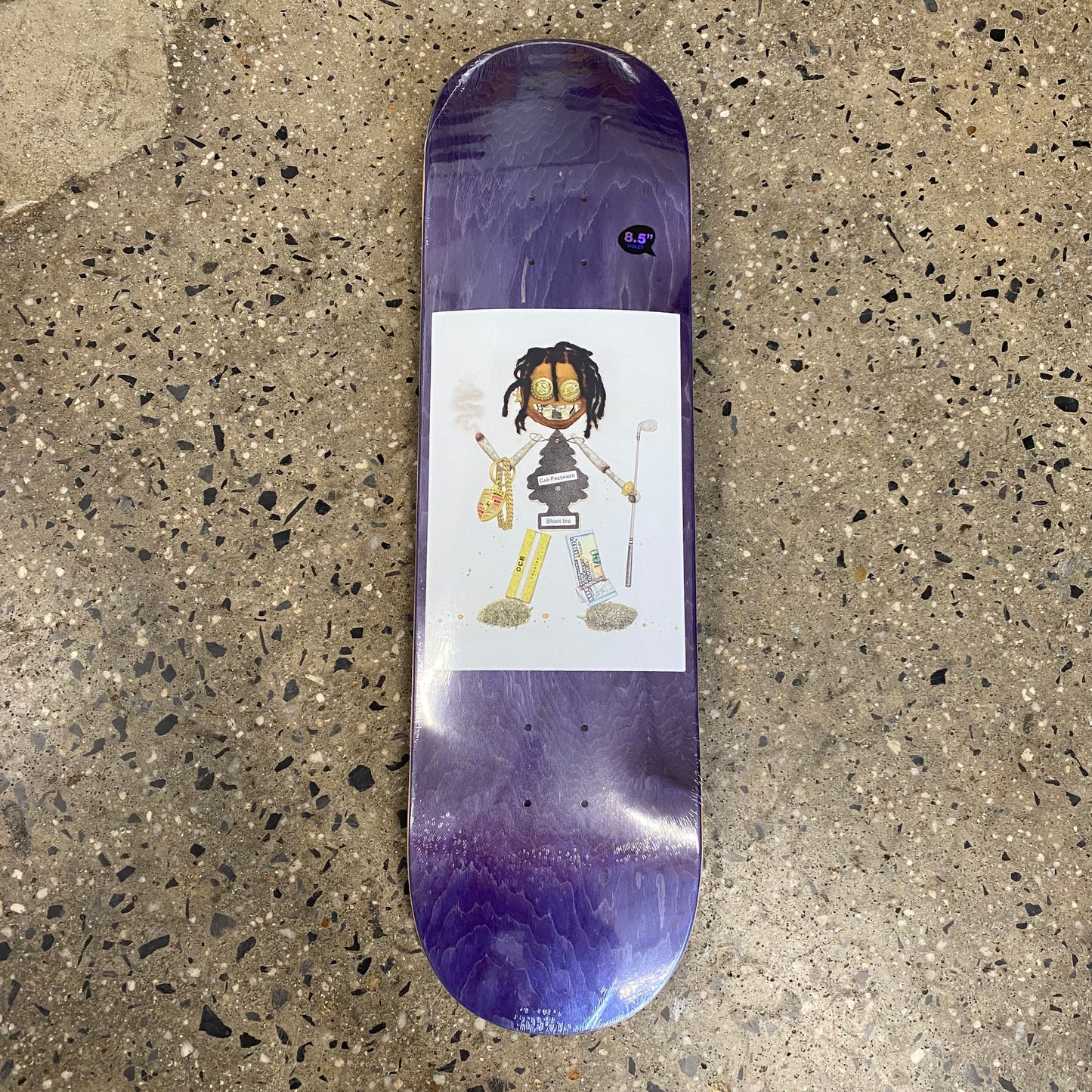 drawing of trash doll on purple wood grain skate deck (wood grain colors may vary)