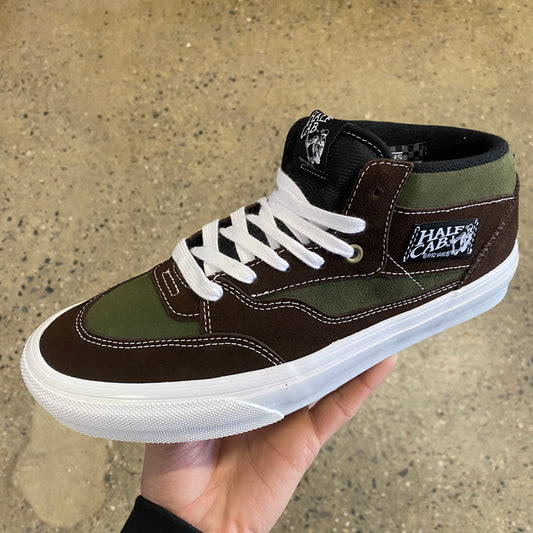 side view of green and brown suede mid top skate sneaker with white sole