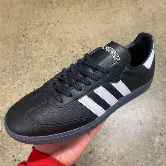 black leather sneaker with white stripes 