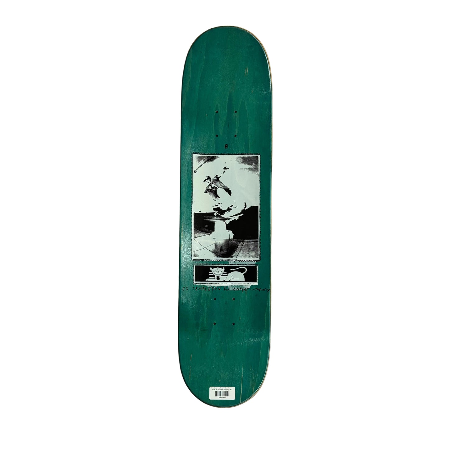 view of top of Green skateboard deck with a black and white graphic on a white surface