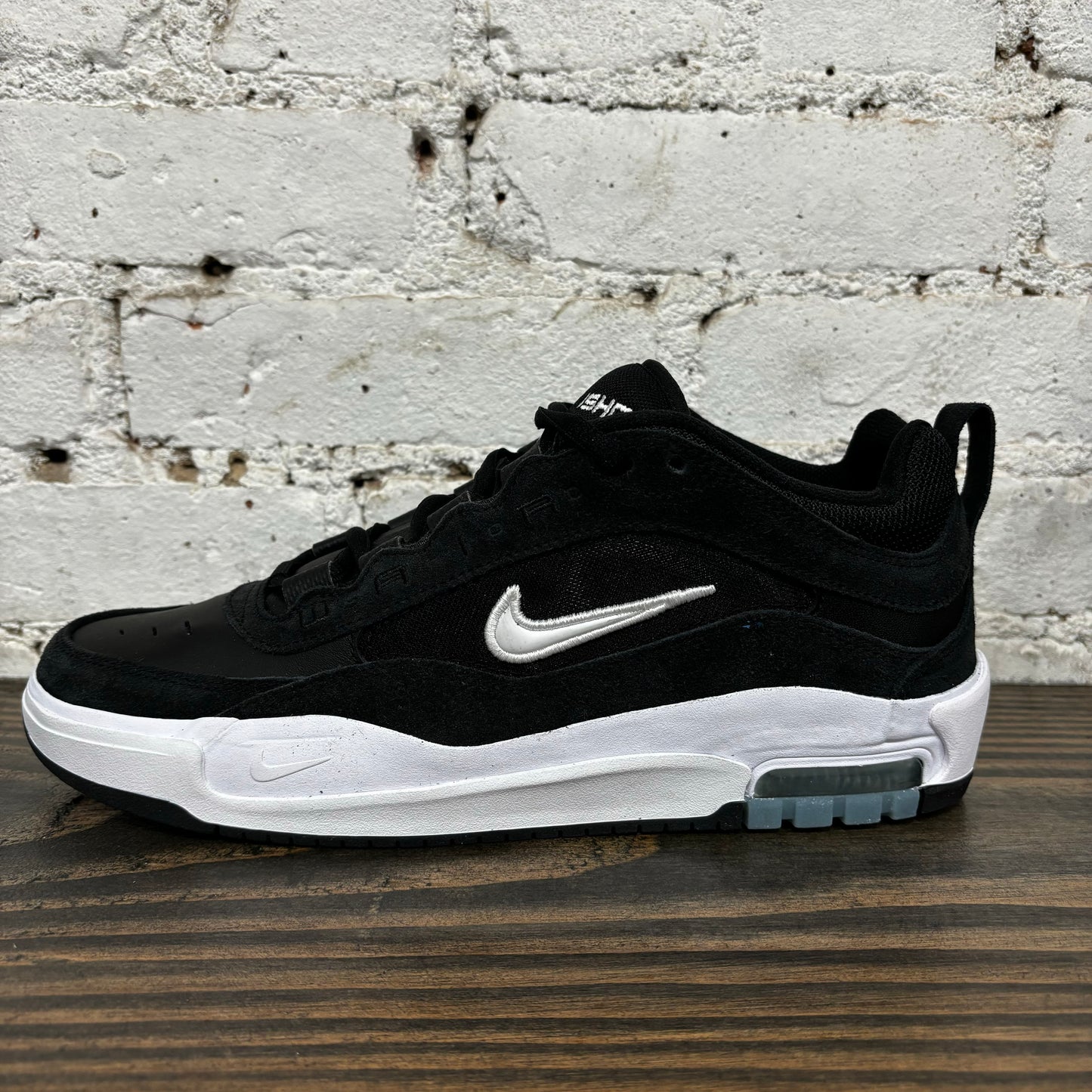 Side view of black and white suede and mesh nike sb skateboard sneaker