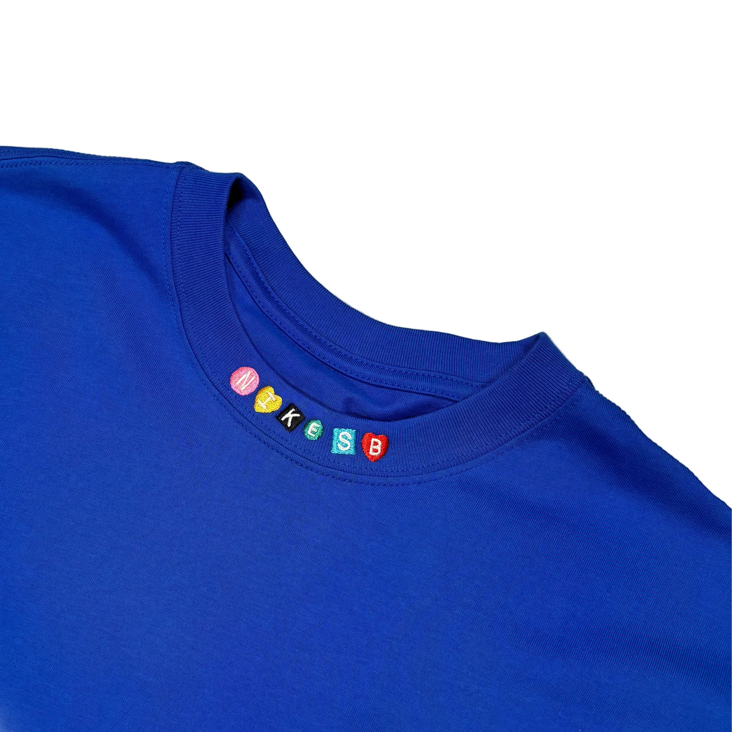 close up view of NIKE SB logo on neckline of shirt