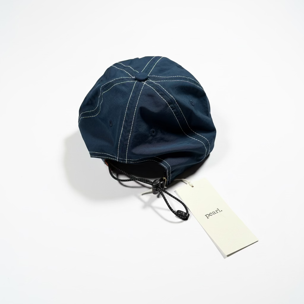 rear of navy hat with white stitching on white background
