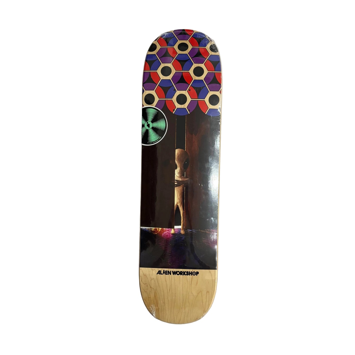 skateboard deck with photo of alien peaking out of the crack in a partially open door with a pattern on the nose of board