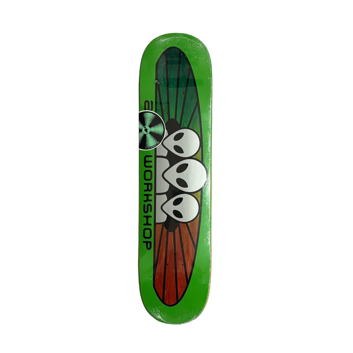 A green skateboard deck featuring a graphic of three white aliens on a red and green wing-like design, with the word 'ALIEN WORKSHOP' printed horizontally, photographed from above on a white background
