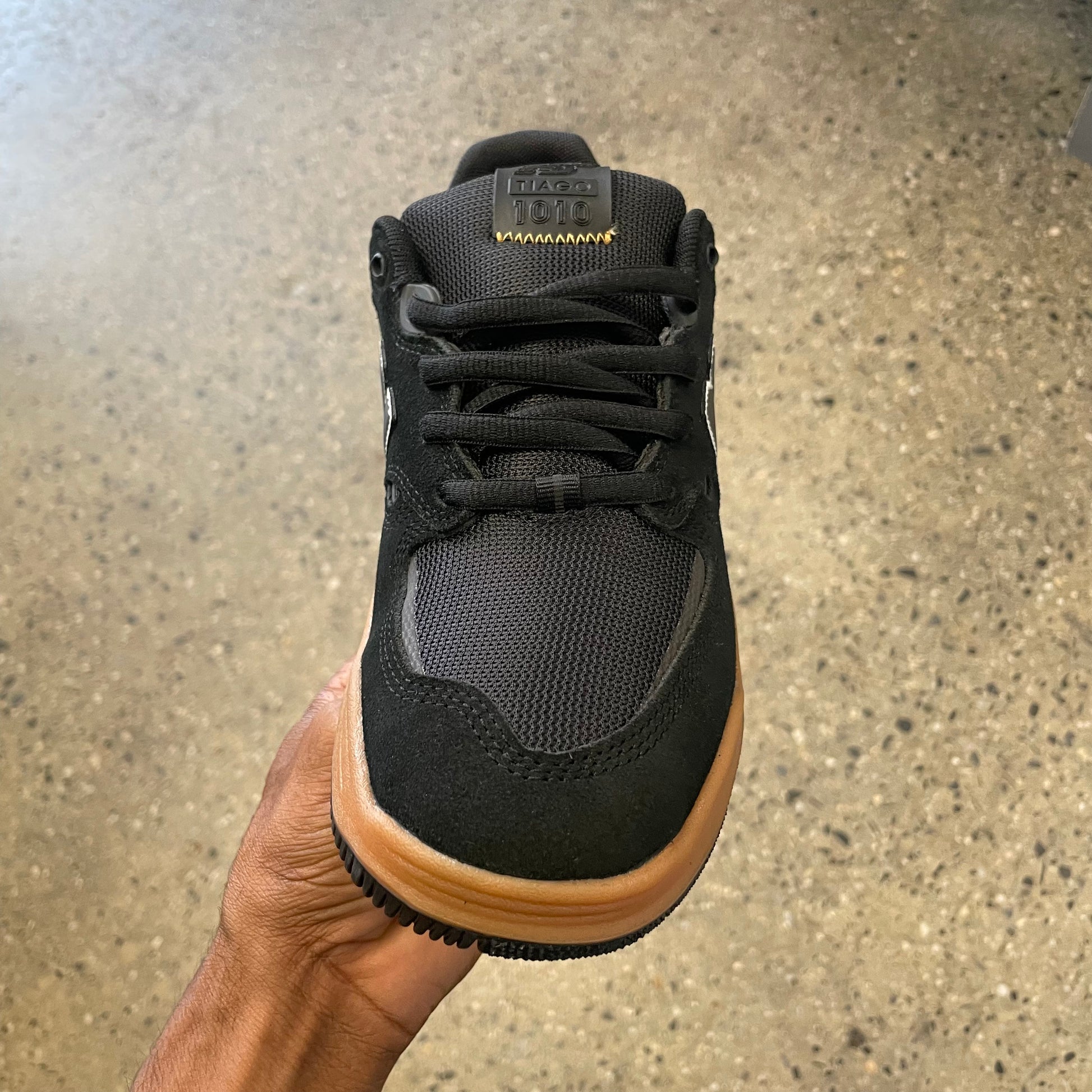black sneaker with gum sole, front view