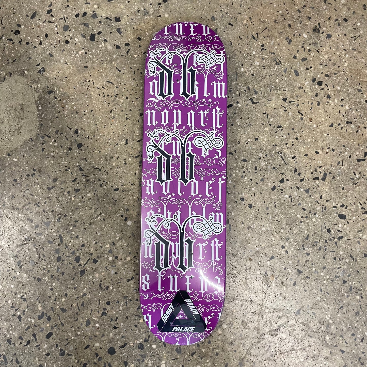 black and white design on purple skate deck