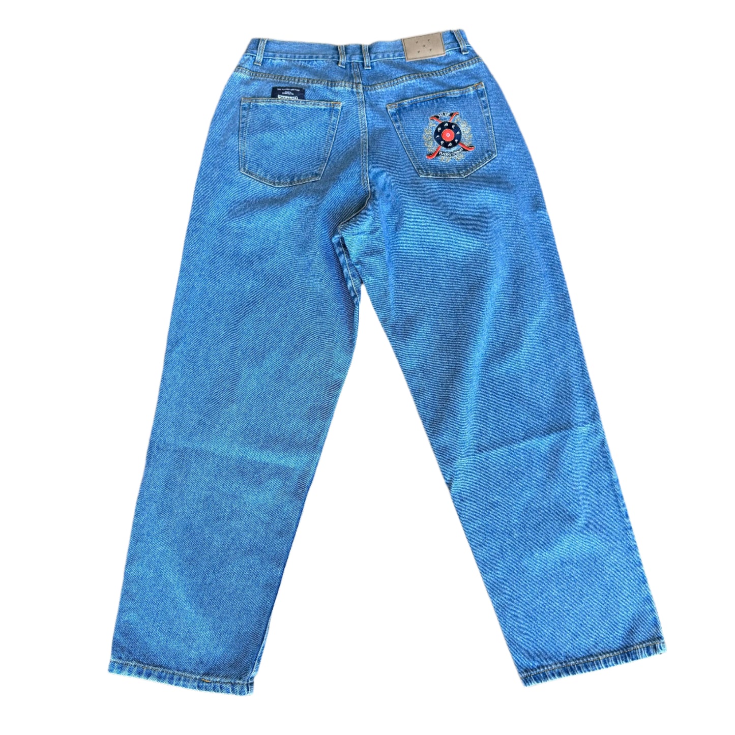 back of the jeans. pop trading co. logo on right pocket and then a pop trading co label slightly above the left pocket