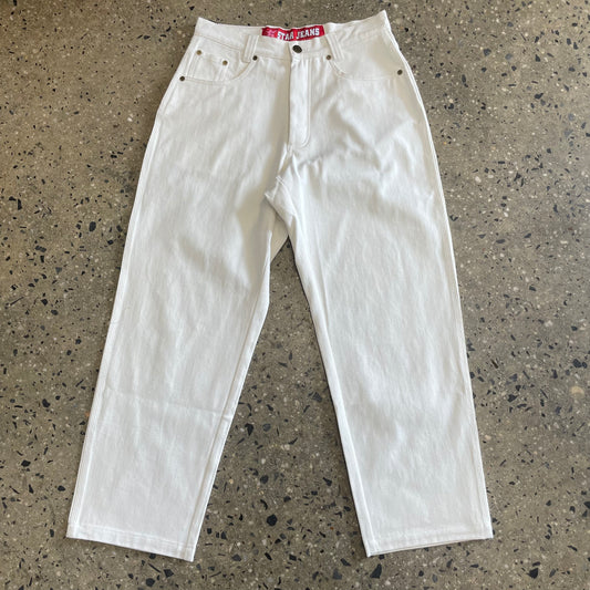 front view of five pocket White denim pant with red tag