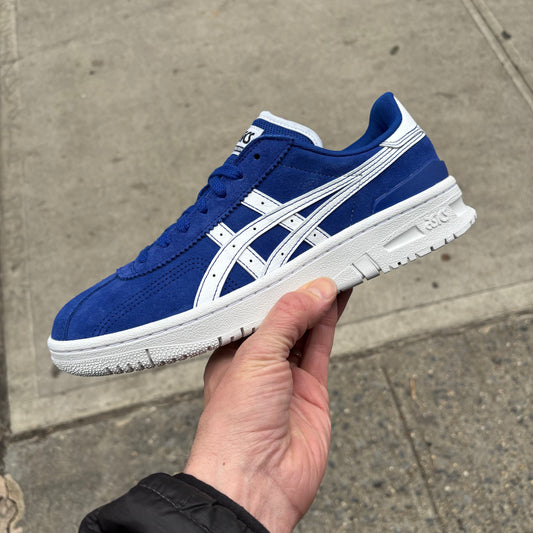 side view of suede royal blue and white skateboard shoe