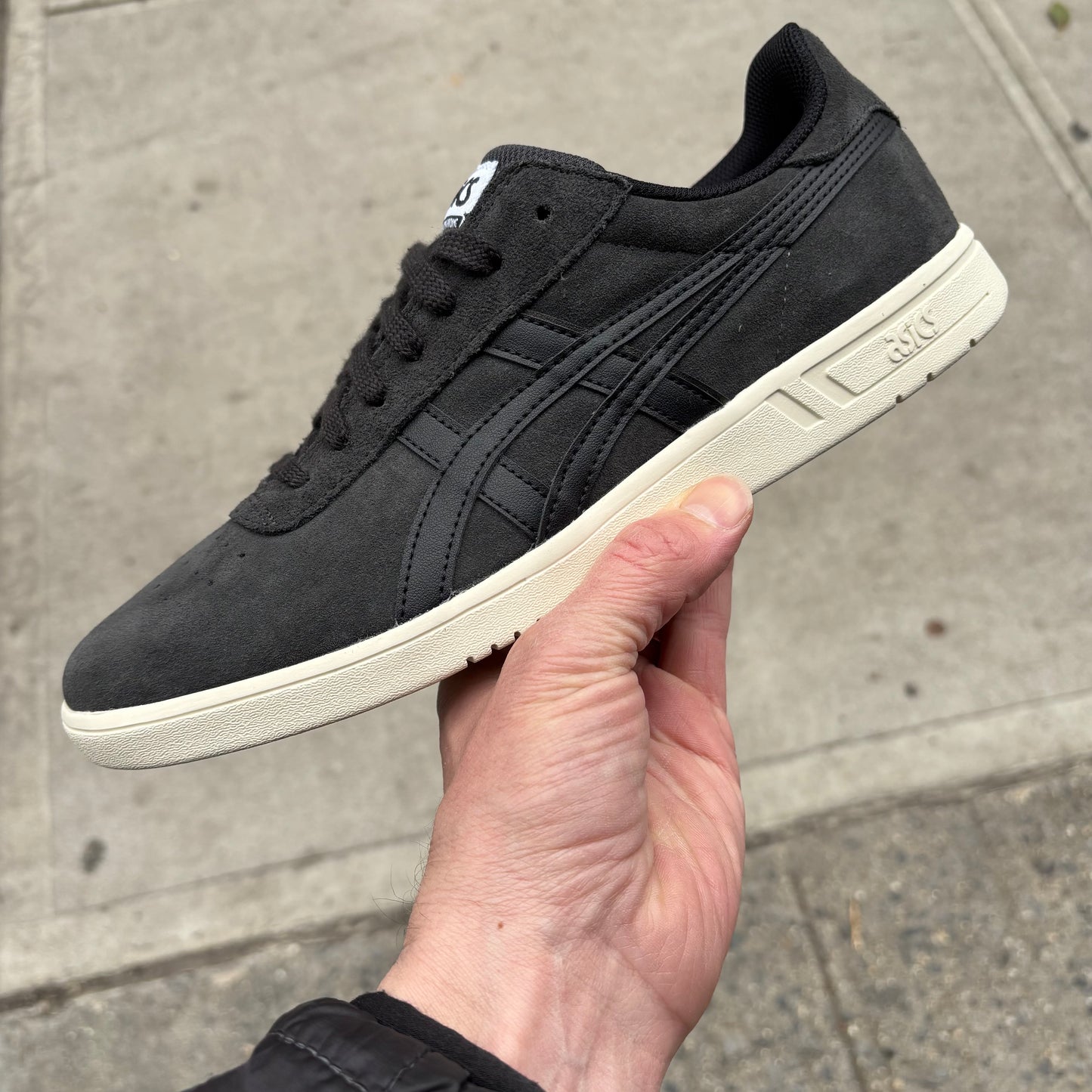 Side view of grey suede skateboard shoe with off white sole