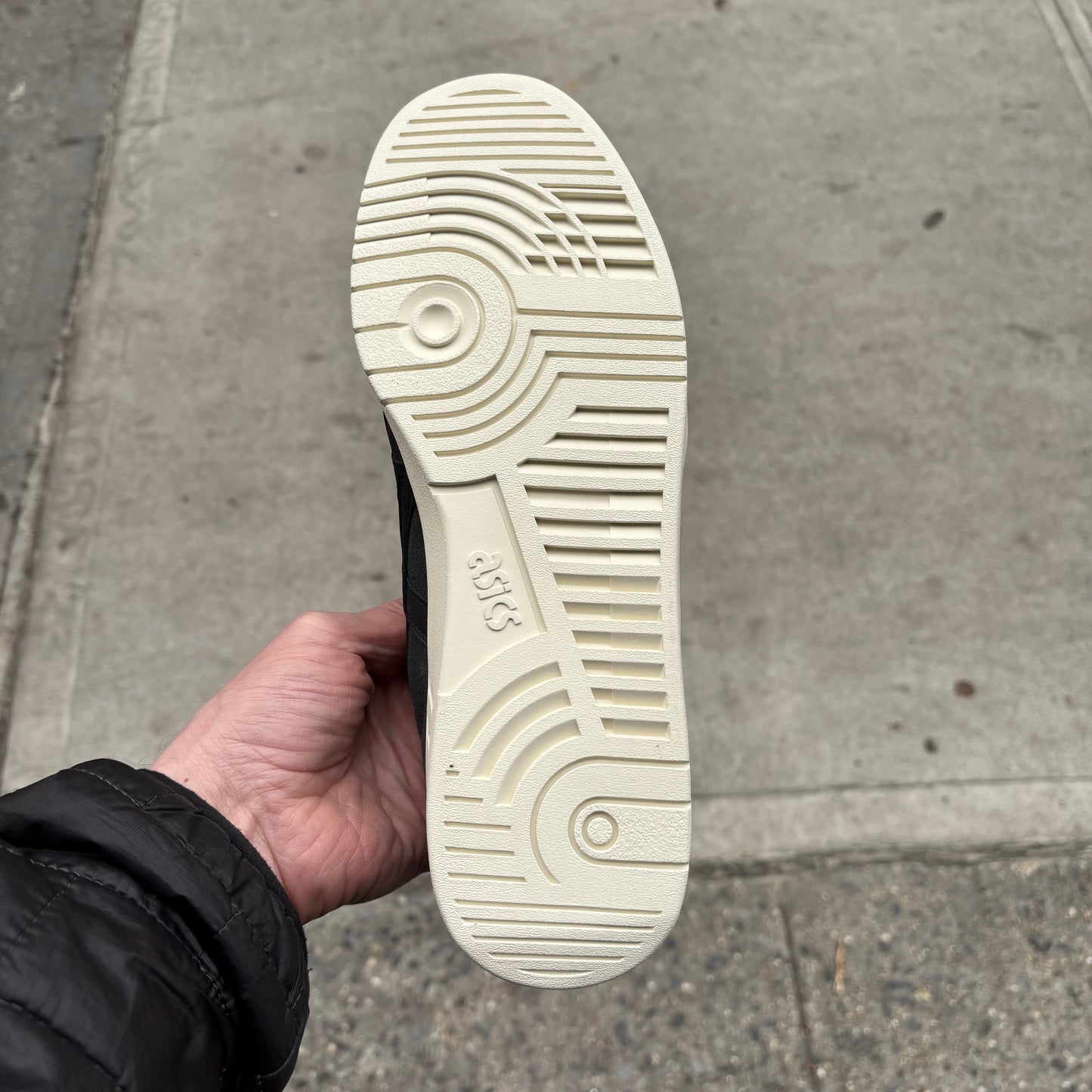 view of white outsole on grey suede skateboard shoe