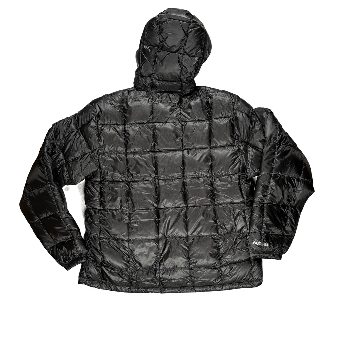 A black hooded puffer jacket laid flat on a white surface. The jacket is shown from the back, featuring a quilted grid pattern and a small white logo on the lower left sleeve.