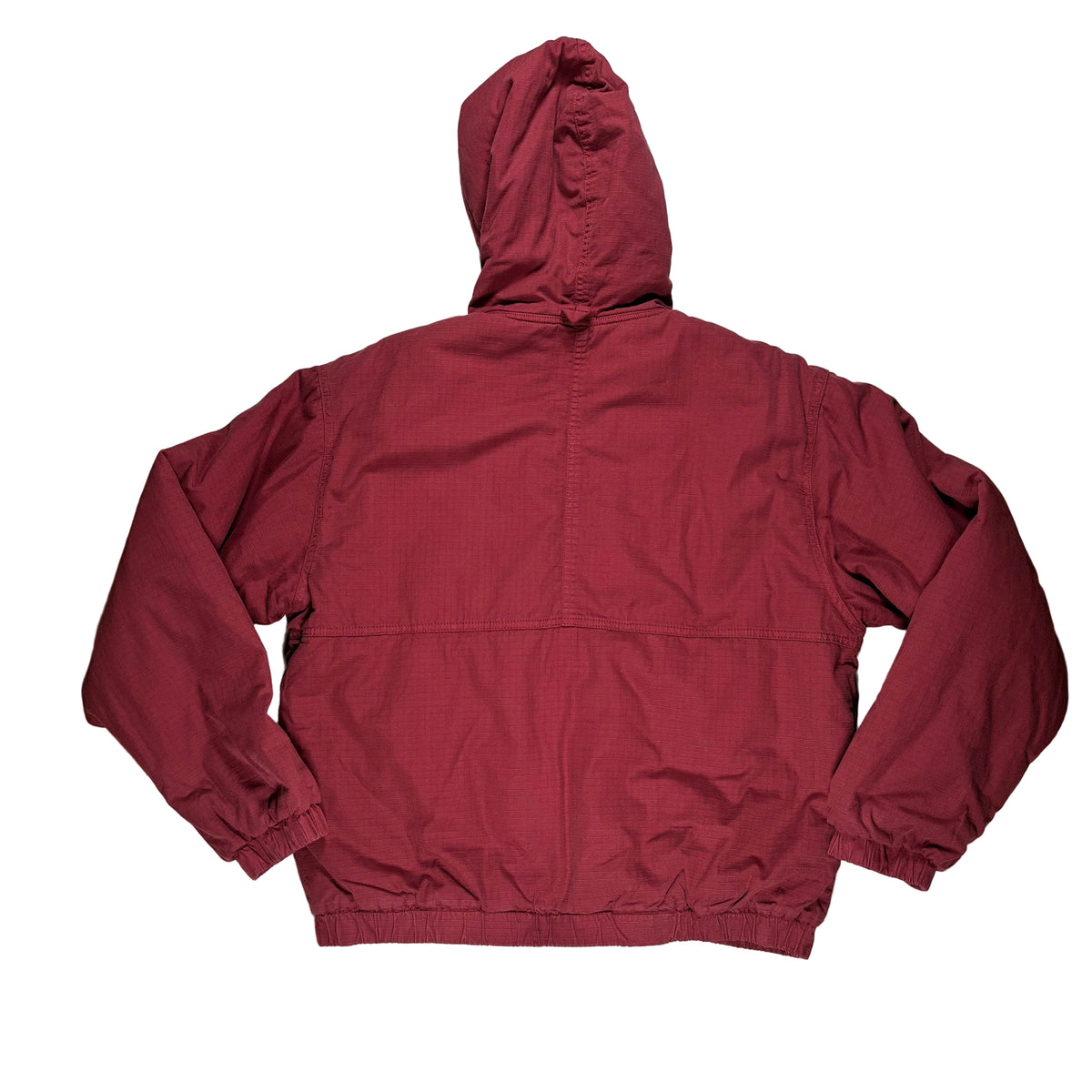 A burgundy hooded windbreaker jacket laid flat on a white surface.