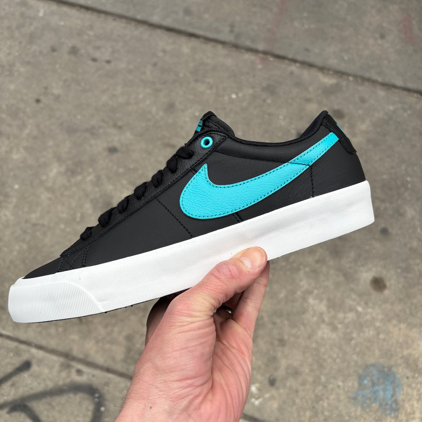 side view of black and teal leather GT blazer low