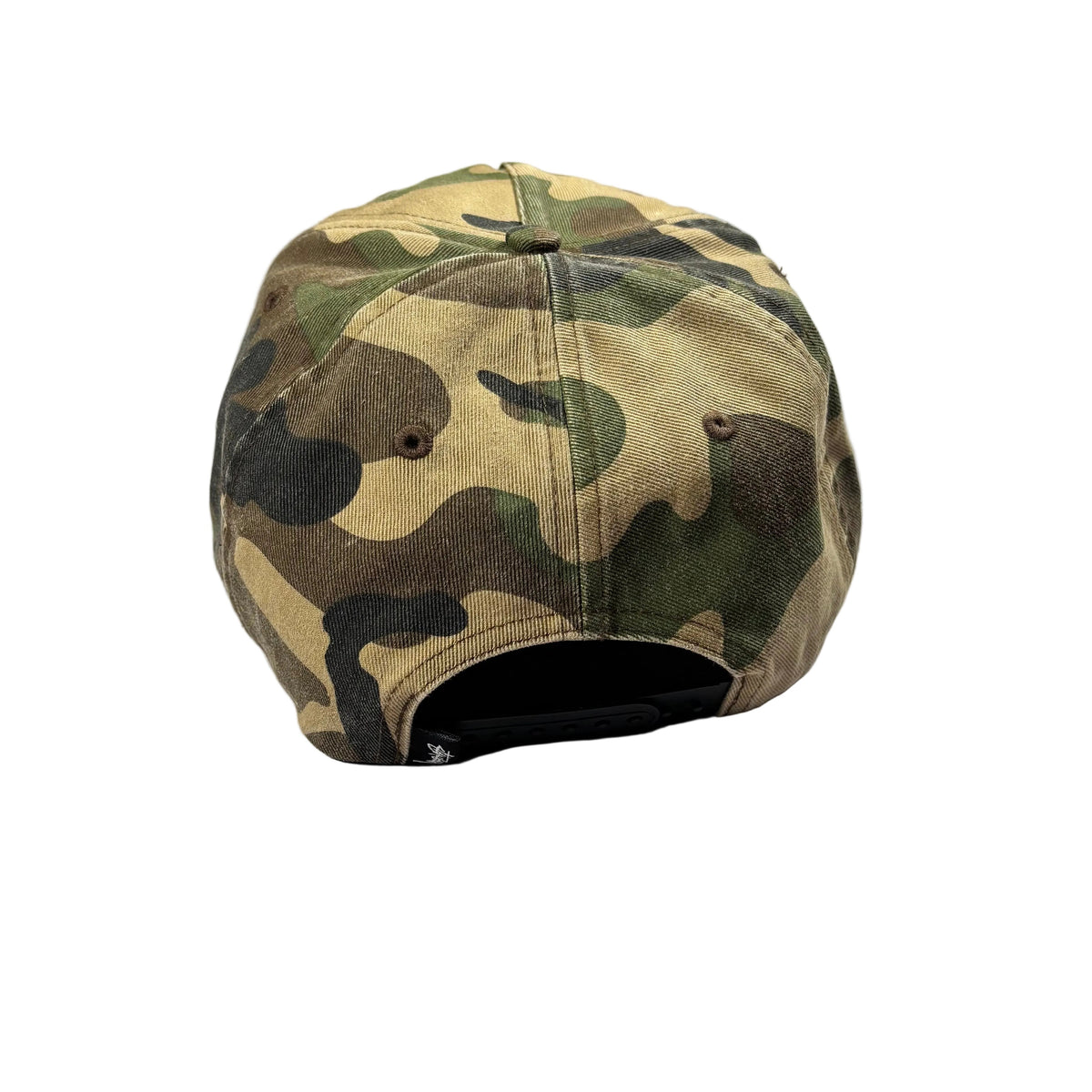 A camouflage baseball cap viewed from the back, resting on a white surface