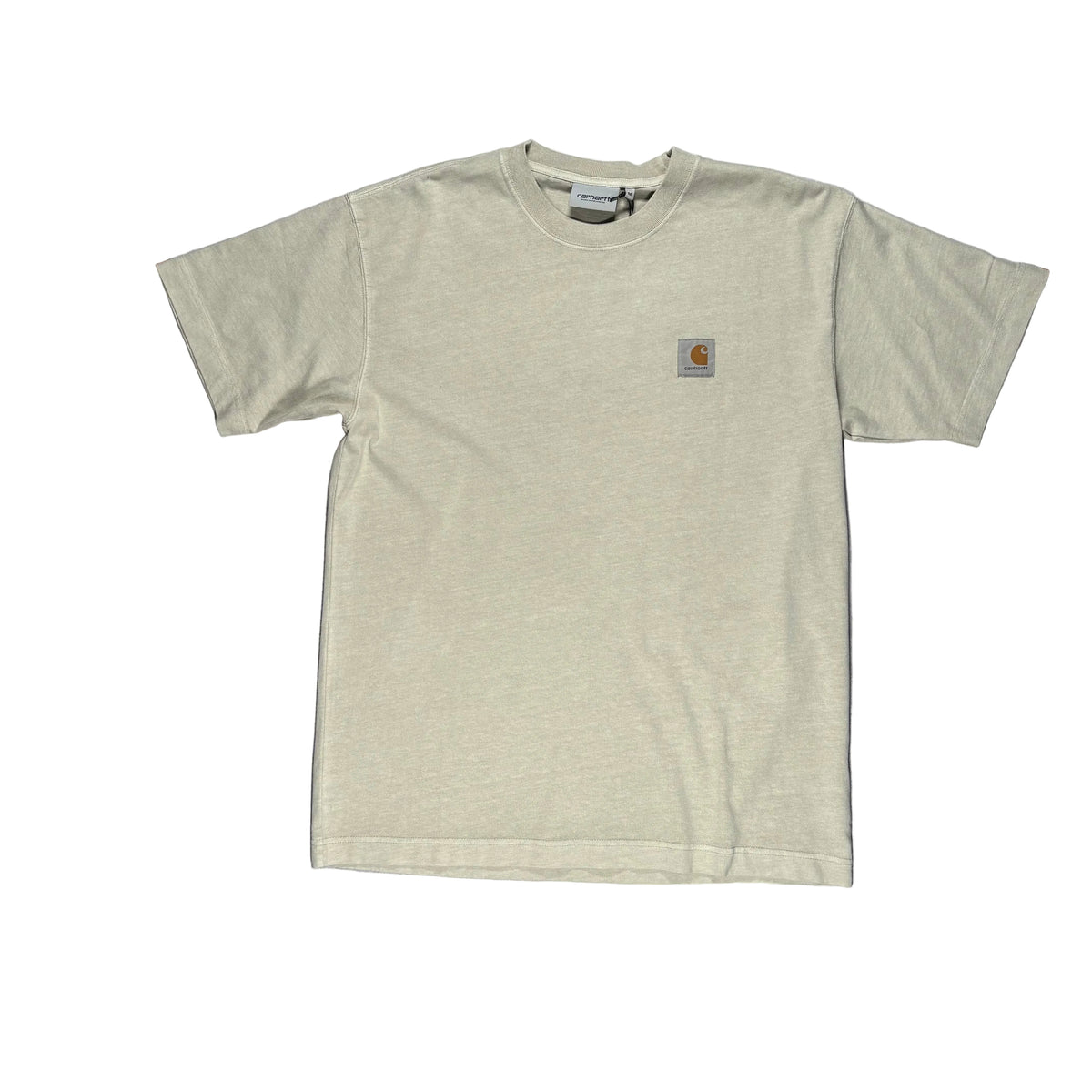 A light beige Carhartt short-sleeve t-shirt laid flat on a white surface. A Carhartt logo patch is visible on the left chest.