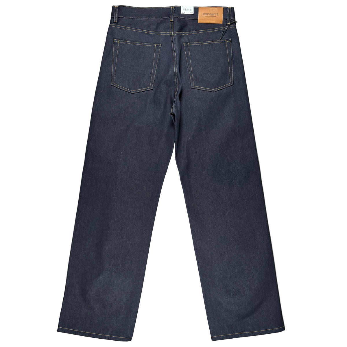 Back view of a pair of dark indigo denim jeans laid flat on a white surface.
