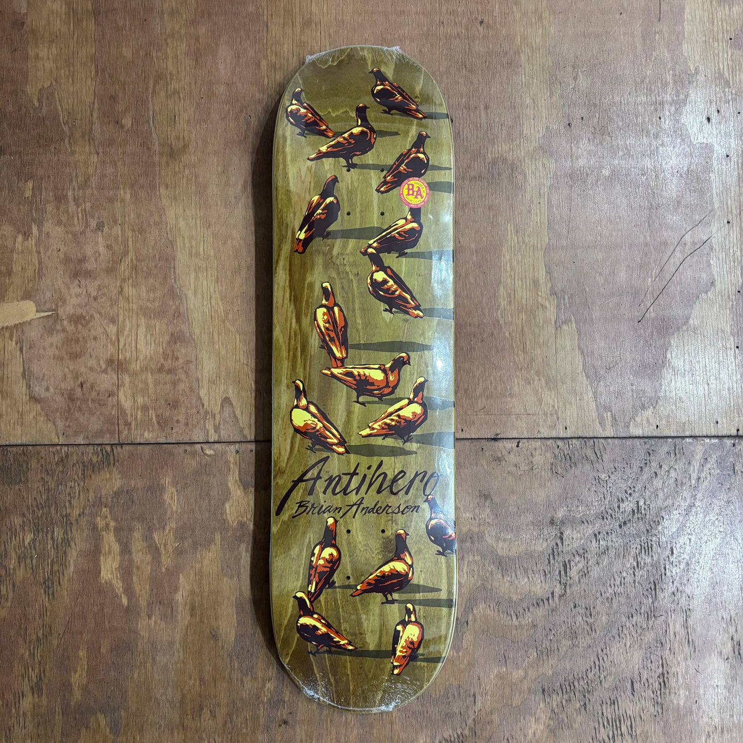 regular Shaped skateboard deck with pigeons prined on woodgrain deck
