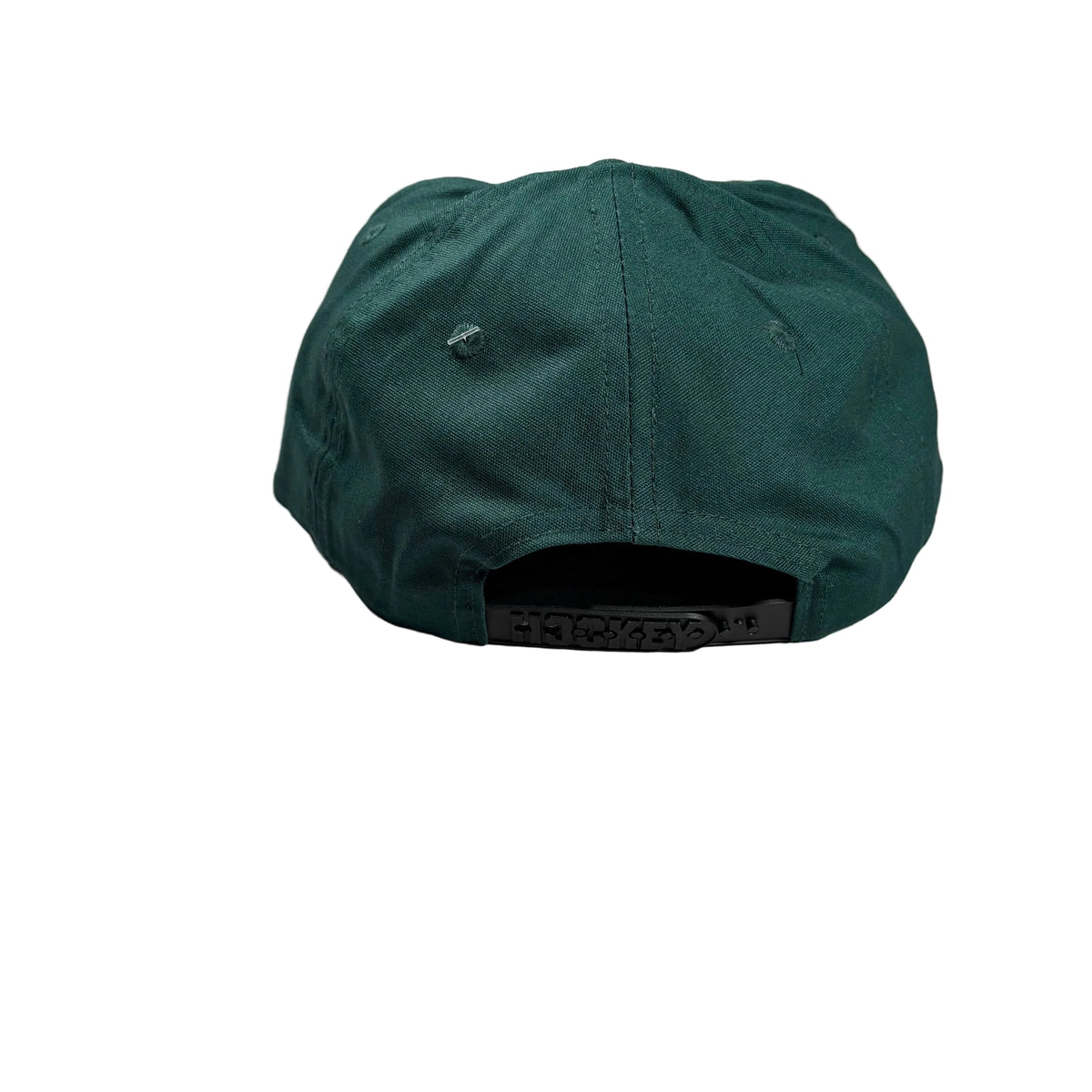 A dark green baseball cap viewed from the back, resting on a white surface.