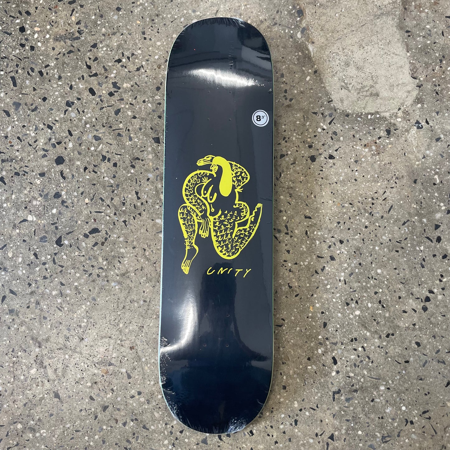 yellow hand drawn woman graphic on black skate deck