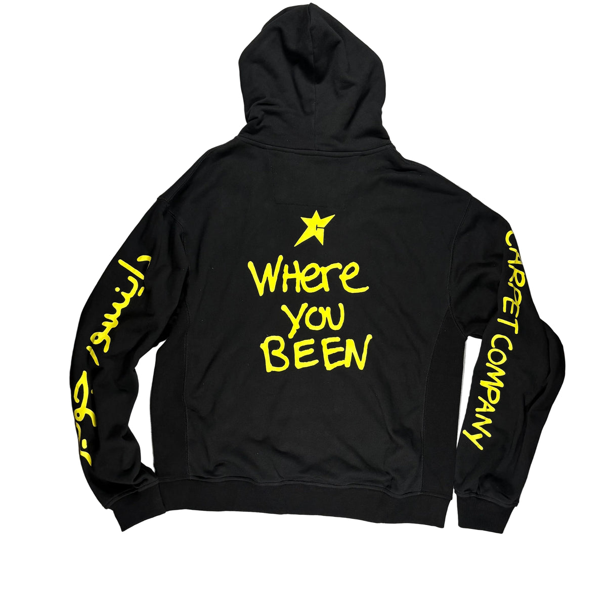 Black hoodie laid flat on a white surface, with bright yellow text and graphics on the back and sleeves. The back reads 'Where You Been' under a star, and the sleeves read 'CARPET COMPANY' and script.