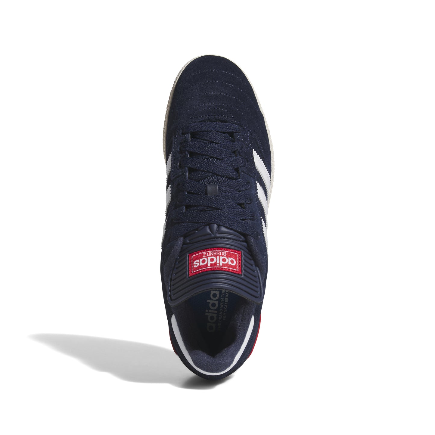 top down view of navy, white suede lowtop soccer style shoe with red accent on heel