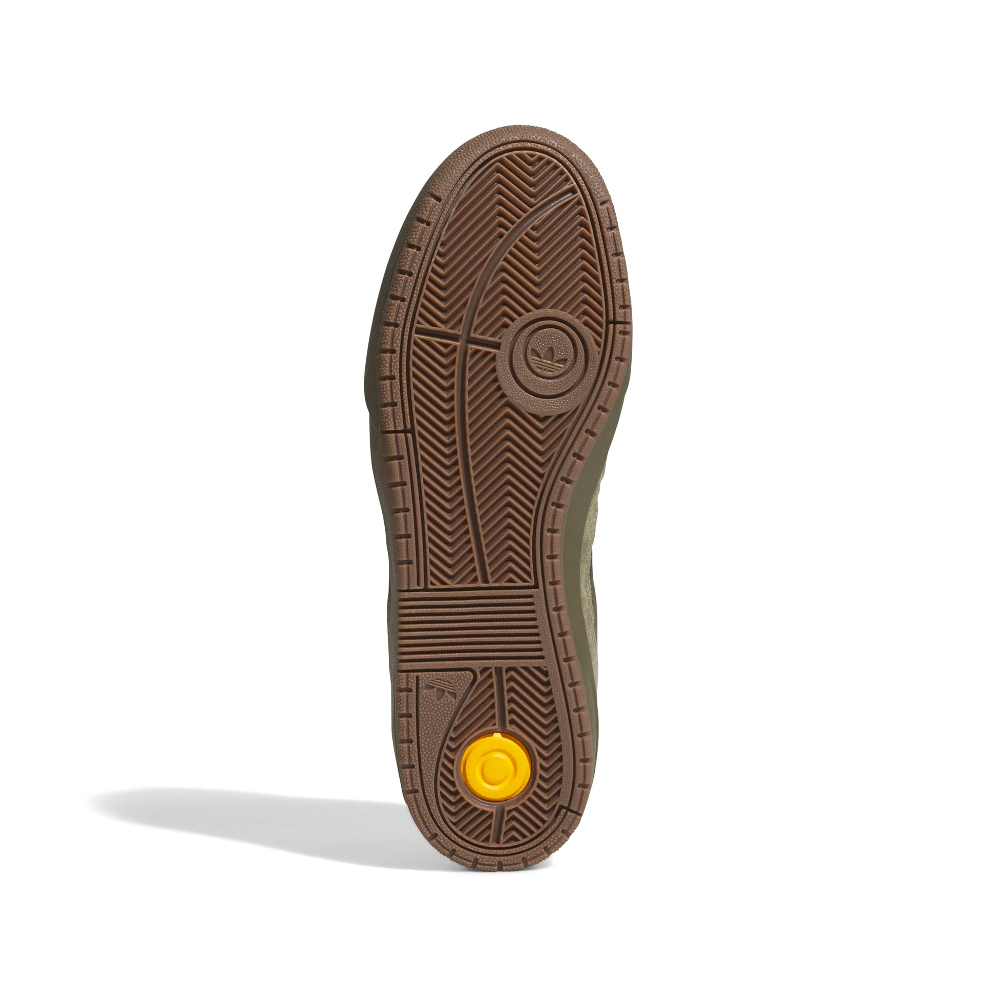 Brown shoe sole with a yellow rubber patch on a white background