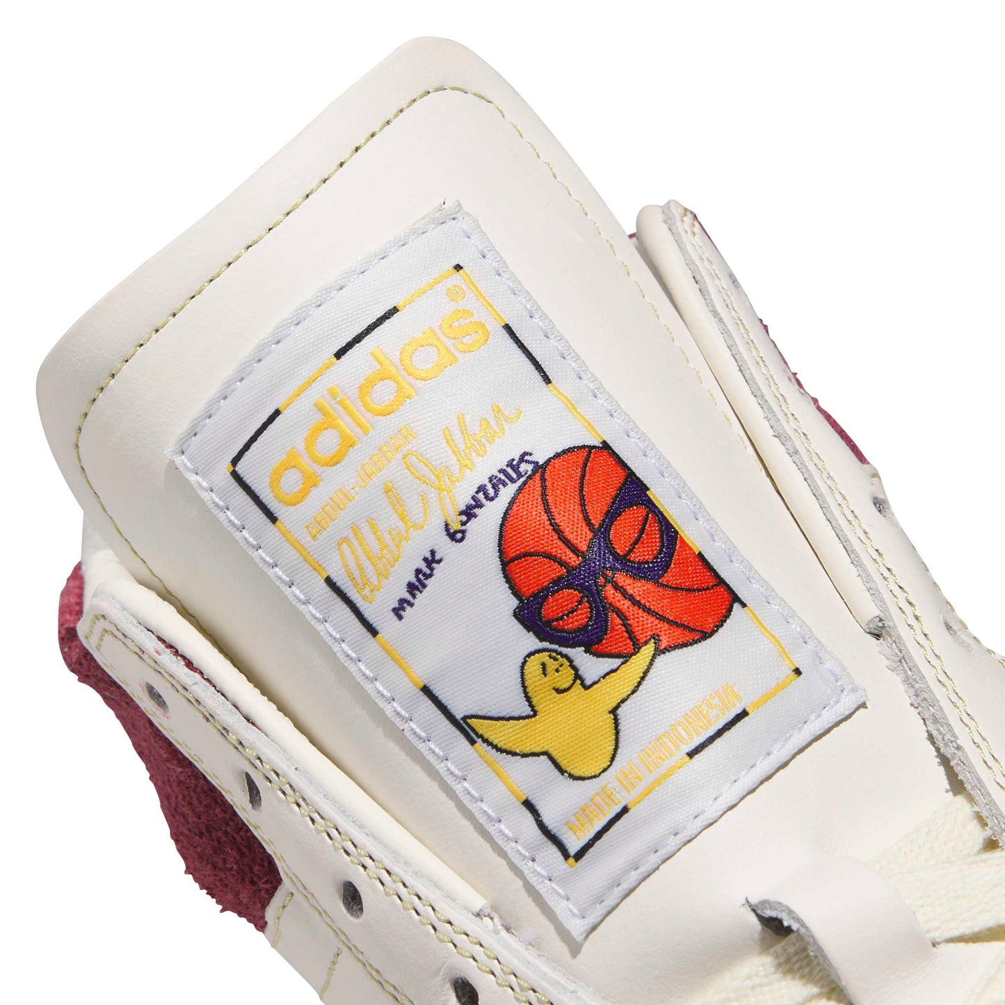 Close-up of an Adidas sneaker with a label featuring a basketball design.