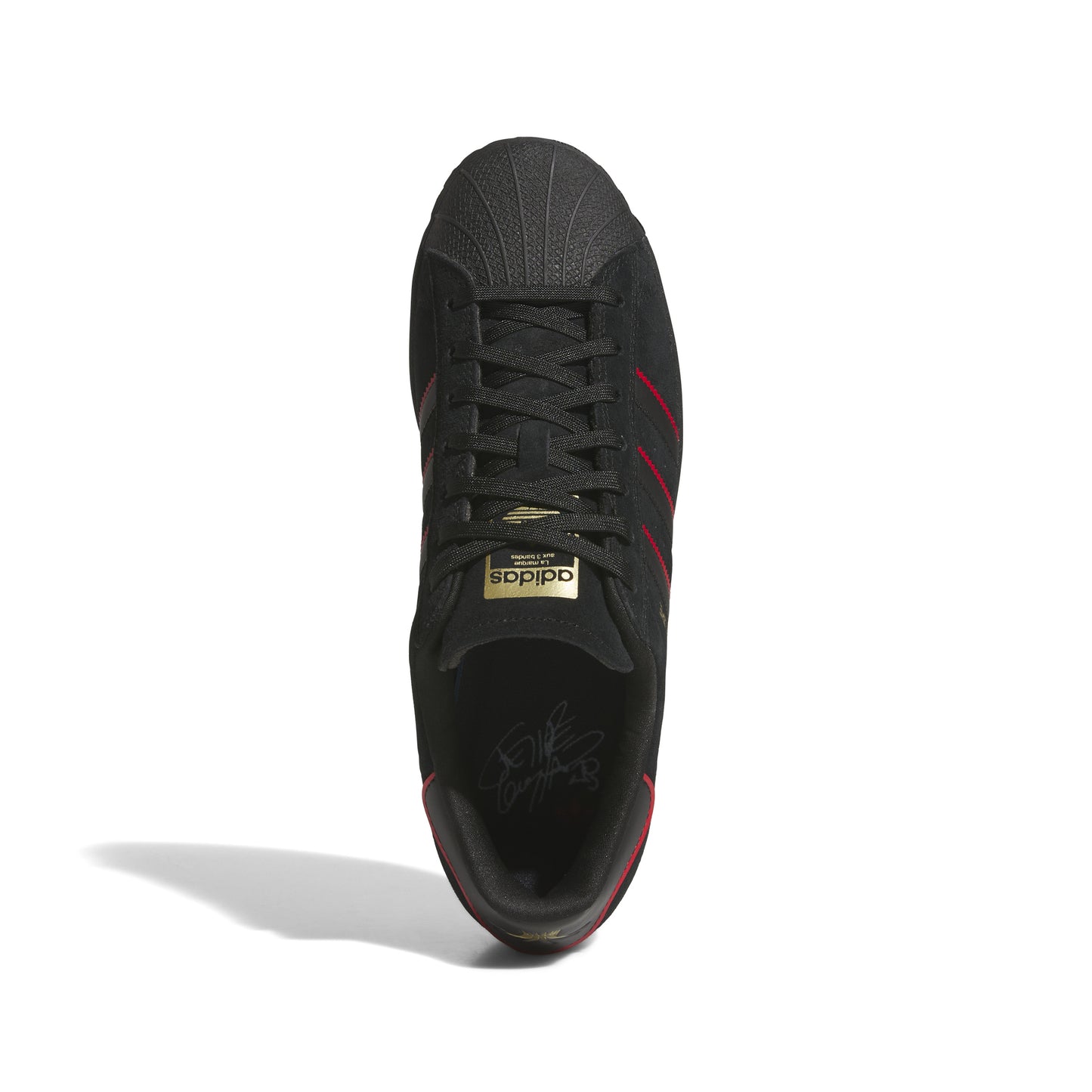 top down view of black nubuck superstar sneaker with red accented stripes