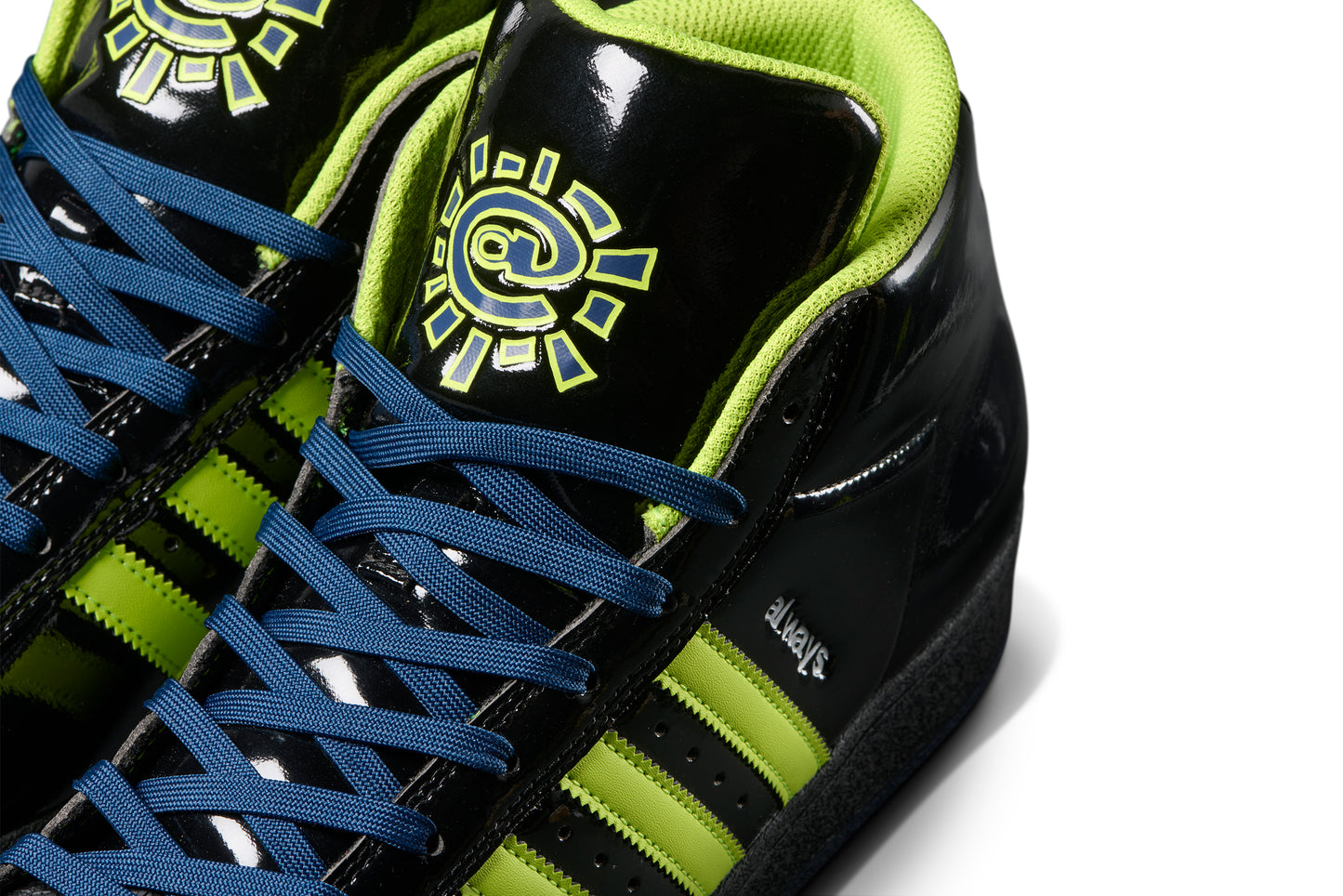 close up view of tongue on black patent leather sneaker with the always do what you should do symbol on the tongue