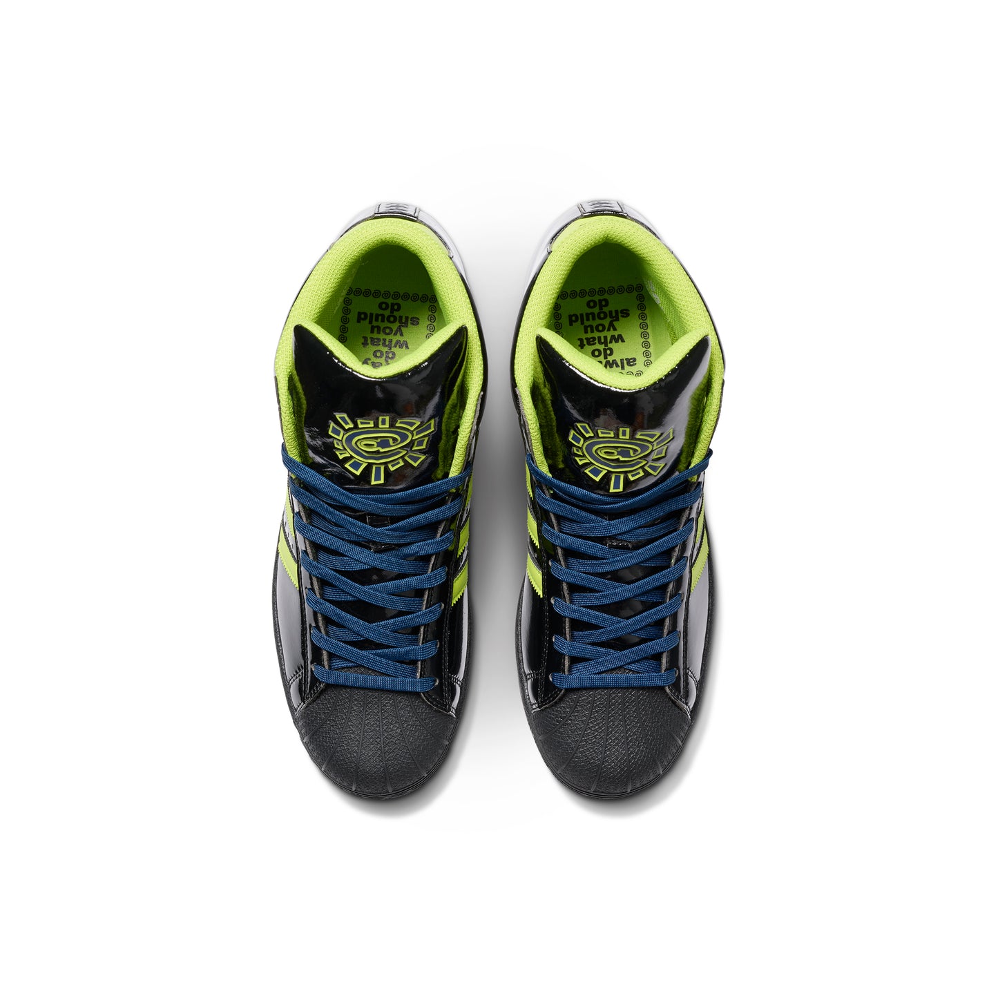 top down view of black patent leather sneaker with green accents, logo on tongue, and navy blue laces